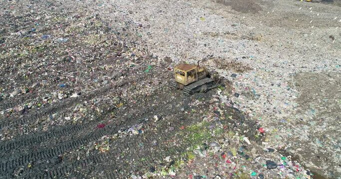 Garbage trucks are working in the waste sorting plant.