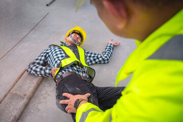 Accident at construction site. Physical injury at work of construction worker. First Aid Help a...
