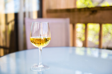Closeup of alcohol hard cider with yellow color drink and carbonated bubbles as sparkling wine in...