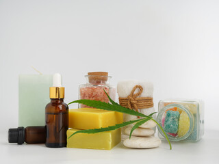 Spa hemp extract products with cannabis leaf soap bar cbd oil  lotion  and himalayan pink salt white towel stone on white background