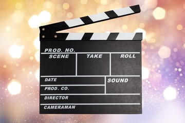 Classic film clapperboard on colored background.