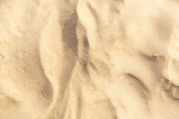 Fototapeta na wymiar Sand texture on the beach. Brown beach sand for background.