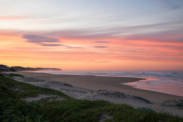 Fototapeta na wymiar A coastal landscape scene with a beautiful pink sunrise