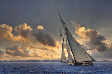 Sailboat sailing in the Mediterranean Sea at sunset