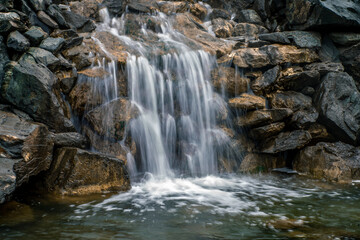 Fototapeta premium A beautiful waterfall. Waterfall on the river. Stone wall with a waterfall. Rocky waterfall
