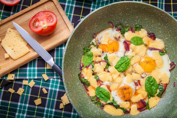 Yellow Scrambled eggs with green spinach and cheese