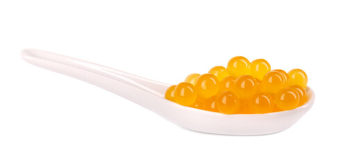 Yellow tapioca pearls for bubble tea isolated on white background. Tapioca pearls in ceramic spoon.