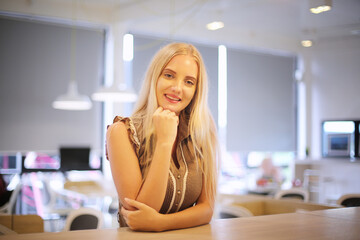 portrait of a beautiful fashion girl with blonde hair posed indoor.