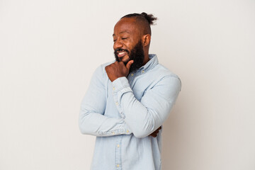 African american man with beard isolated on pink background smiling happy and confident, touching chin with hand.