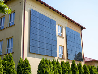 Solar panels installed on the outer wall of building. Wall of the building is tiled with solar panels.