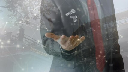 Animation of network of connections floating over businessman throwing and catching nuts and bolts - Powered by Adobe