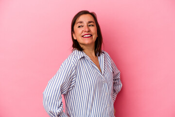 Fototapeta premium Middle age caucasian woman isolated on pink background laughs happily and has fun keeping hands on stomach.