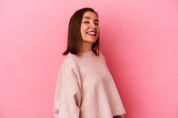 Middle age caucasian woman isolated on pink background confident keeping hands on hips.