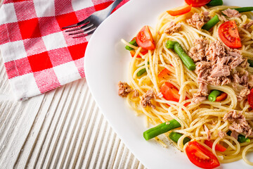 delicious traditional Italian pasta with tuna on a white rustic wooden background