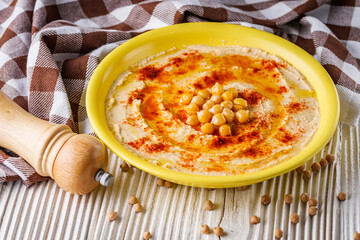 traditional turkish hummus on a white wooden rustic background