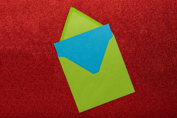 Envelope with blank space for text or greeting on a red background, a symbol of getting mail, advertisement element. Corresponds in office, greeting card mockup. New year card.