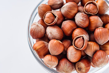 fresh natural hazelnuts on a white acrylic background