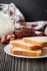 toasts with chocolate butter on a dark wooden rustic background