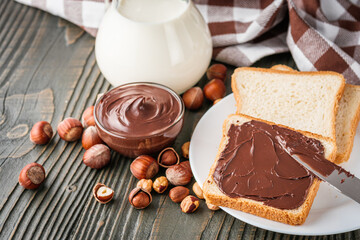 toasts with chocolate butter on a dark wooden rustic background