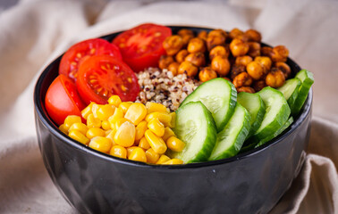 bowl of healthy quinoa with vegetables on a white rustic wooden background