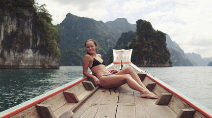 Young Happy Mixed Race Girl Sitting and Relaxing on Traditional Thai Wooden Long Tail Boat at Khao...