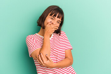 Young mixed race woman isolated on blue laughing happy, carefree, natural emotion.