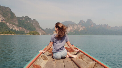 Young Happy Mixed Race Girl Sitting and Relaxing on Traditional Thai Wooden Long Tail Boat at Khao...