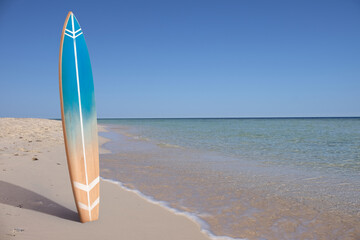 Wooden surfboard on sea beach
