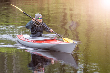 diagonal view portrait kayaker on river forest landscape and reflections