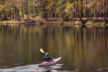 portrait kayaker on autumn river forest landscape and reflections