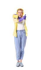 Young woman with detergent and sponge on white background