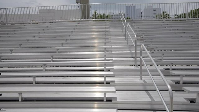 Slow motion passing by empty stadium bleachers aluminum