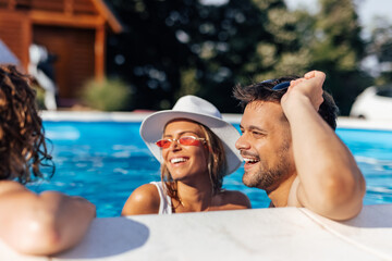 Adult people, making plans about tonight, at the pool.