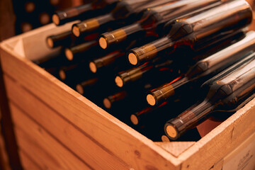 Bottles of wine with corks in wooden crate