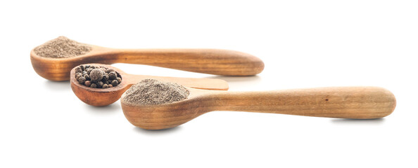 Spoons with black pepper powder and peppercorns on white background