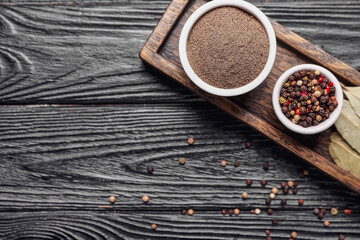 Tray with different spices on dark wooden background
