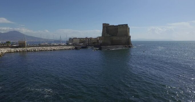 Aerial Drone footage view of Castle Dell&rsquo;Ovo in Naples Italy seaport sea evening  // no video editing
