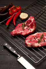 Fresh raw beef or pork steaks on grill grate