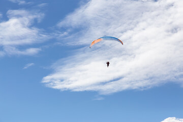 Adventurous People Flying on a Paraglider around the mountains. Savona, British Columbia, Canada.