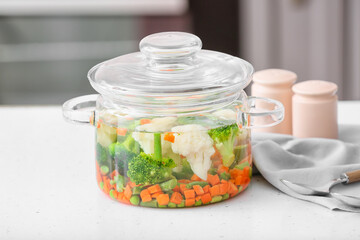 Stylish cooking pot with tasty soup on kitchen counter