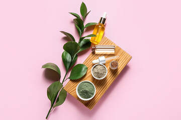 Tray with henna powder and essential oil on color background