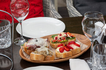 Assorted bruschetta with various toppings. Appetizing bruschetta or crudo crostini. Variety of small sandwiches. Mix bruschetta