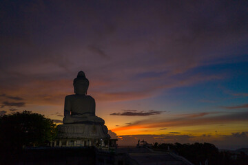 aerial view scenery sunset with rain clouds moving summer..beautiful silhouette Phuket big Buddha on the hilltop.. Another incentive to attract tourists to visit. popular landmark of Phuket
