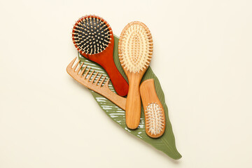 Composition with hair brushes and comb on color background - obrazy, fototapety, plakaty