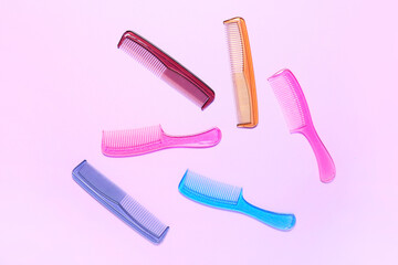 Different hair combs on color background