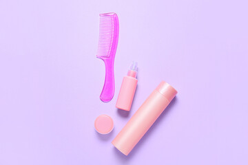 Hair comb and cosmetics on color background