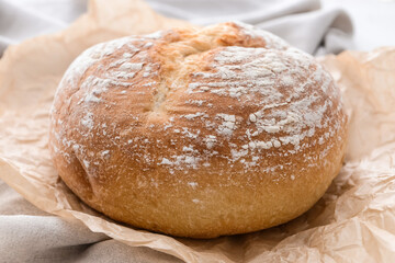 Loaf of sourdough bread on parchment