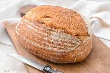 Loaf of sourdough bread on grunge background