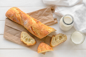 French baguette on white wooden background