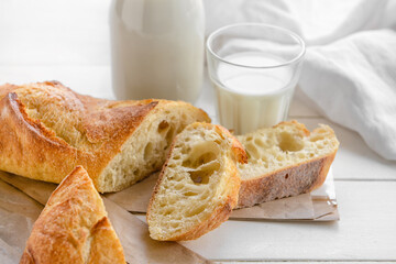 French baguette on white wooden background